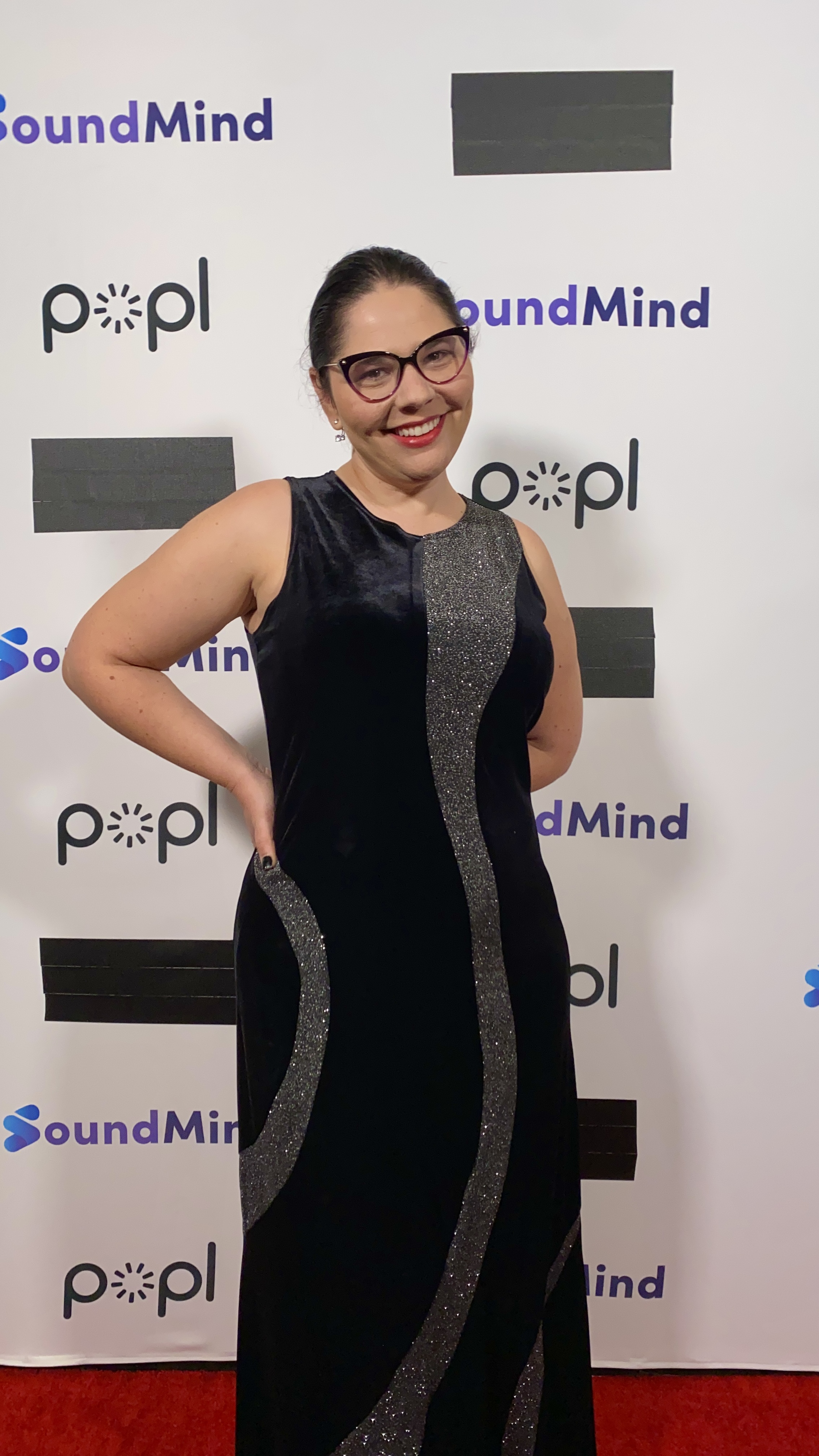 Christine barger on the red carpet in a black and silver floor length gown